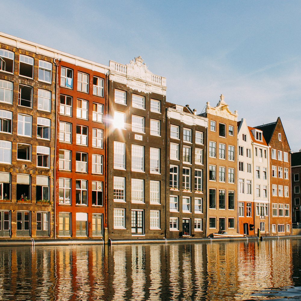 Gabled canal houses reflected in low golden light.