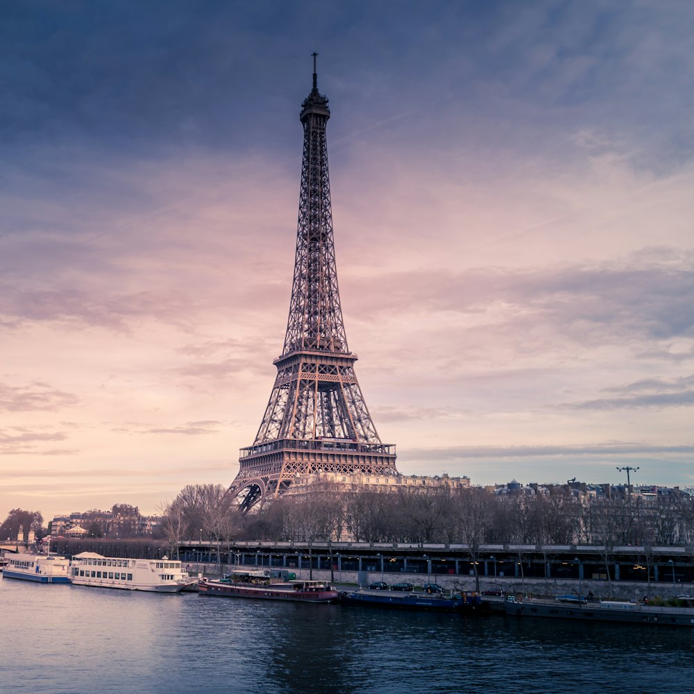 An iron tower above a river at dusk.
