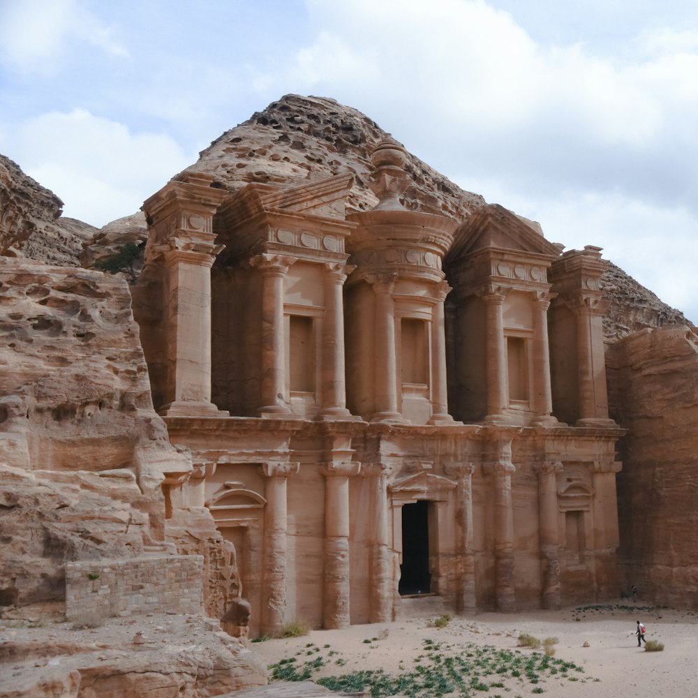 A columned facade carved into a rose-red cliff.